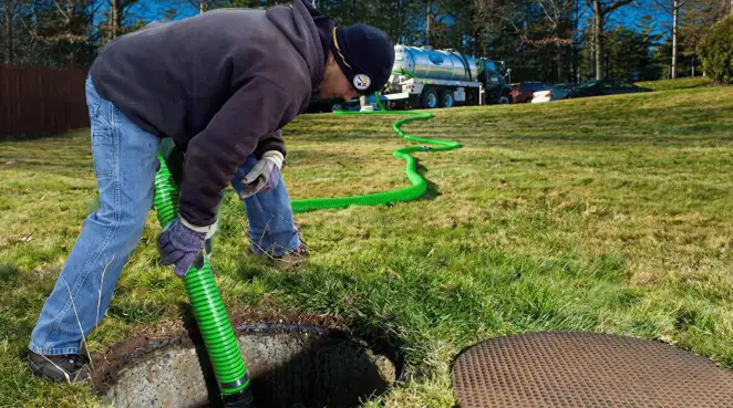 Service technician performing residential septic pumping and drainage maintenance in Buffalo, NY